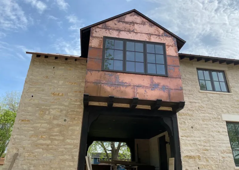 Copper metal panel facade on a stone building for Roof Repair in Clifton Park