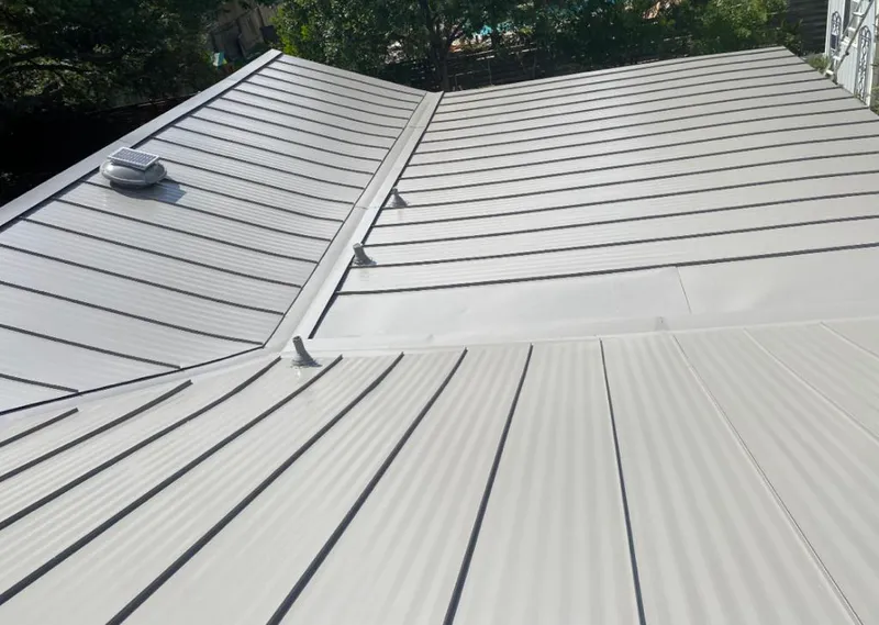 Solar attic fan installed on a metal roof for Roof Ventilation in Clifton Park